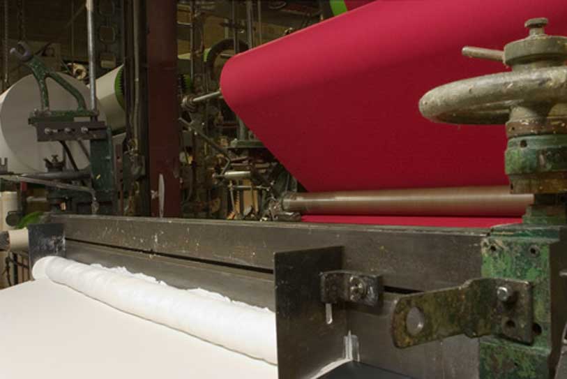 USFMA-Shipping-6 red fabric on rollers in a manufacturing machine